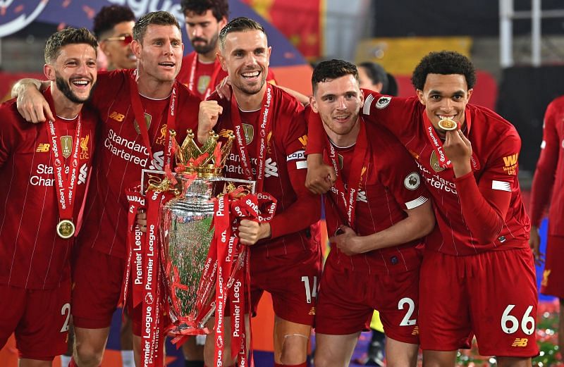 Jordan Henderson celebrates their Premier League win with Liverpool players.