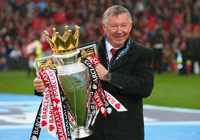 Sir Alex Ferguson holding his 13th Premier League title as United manager