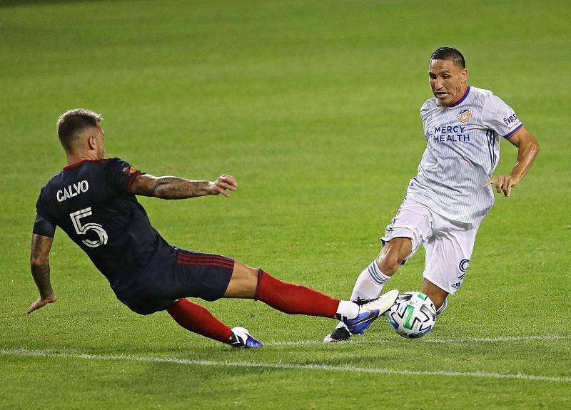 Francisco Calvo of Chicago Fire knocks the ball away from Adrien Regattin of Cincinnati