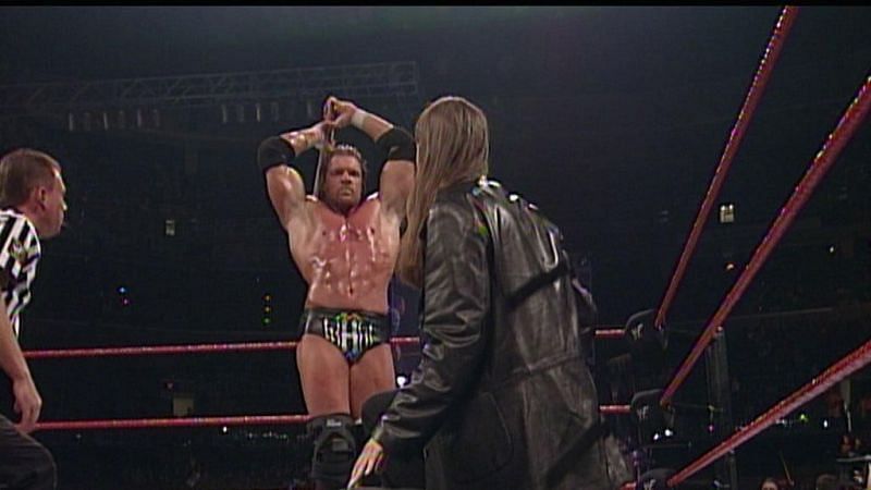 Triple H pretending to attack Stephanie