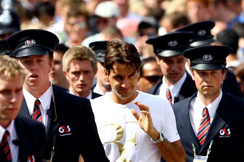 Roger Federer with his security detail at Wimbledon 2009