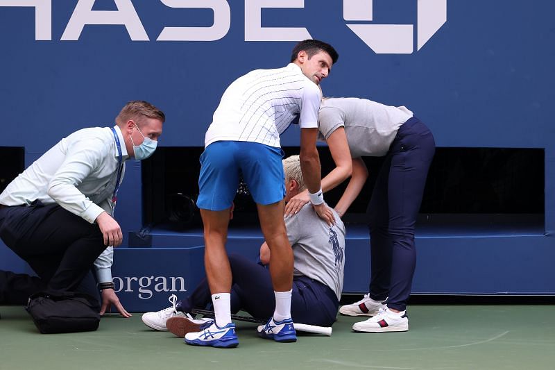 Novak Djokovic tending to the lineswoman