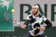 Jack Sock hits a volley