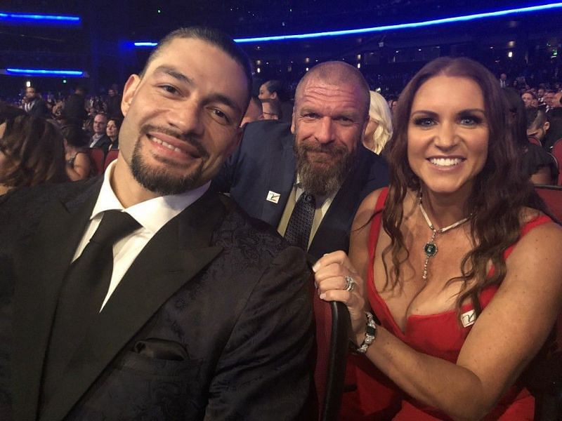 Stephanie with Roman Reigns and Triple H