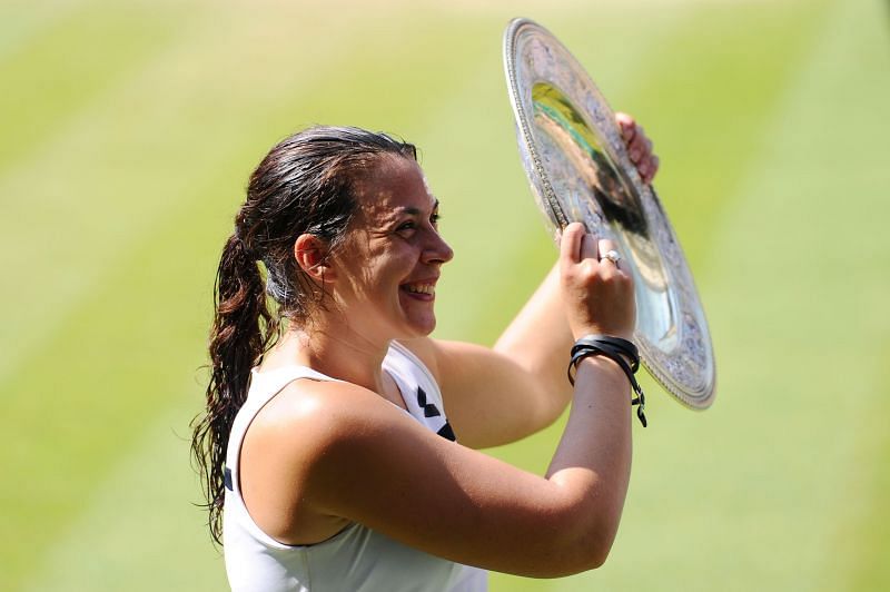 Marion Bartoli with the Venus Rosewater Dish trophy after winning the Wimbledon singles title in 2013