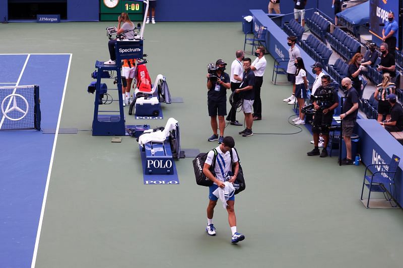 Novak Djokovic leaving the court after being defaulted.