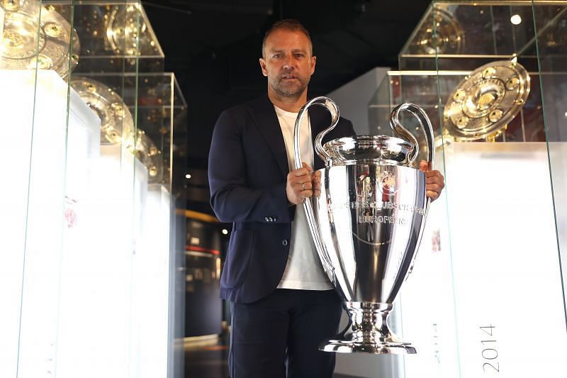 Bayern Munich manager Hans-Dieter Flick hands over the UEFA Champions League trophy to the FCB museum.