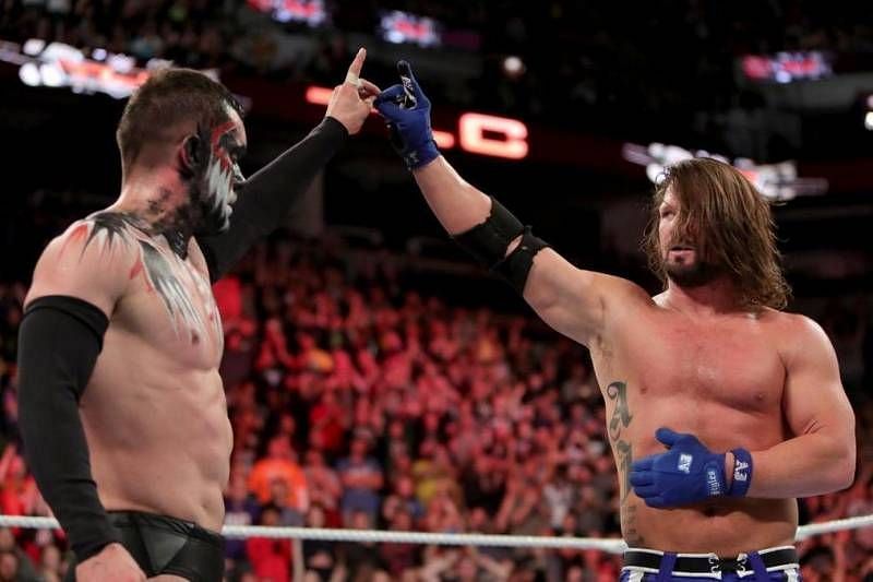 Finn Balor sharing a Too Sweet with AJ Styles