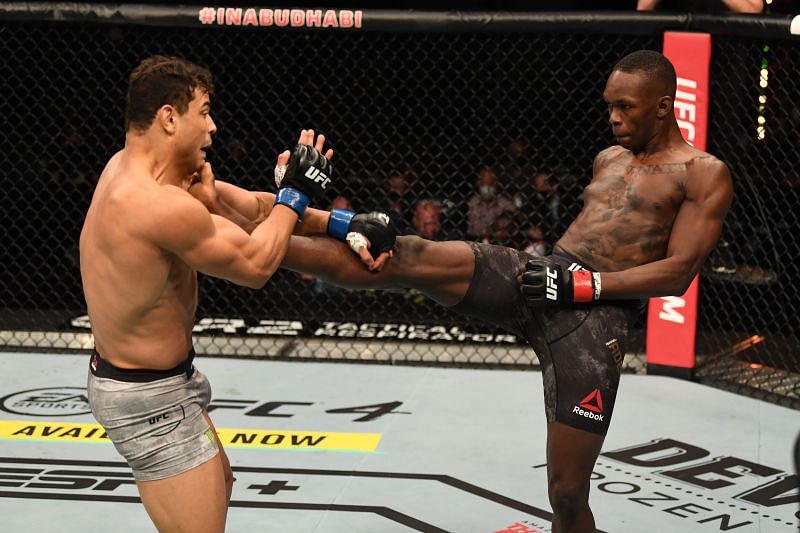 Israel Adesanya kicks Paulo Costa during their middleweight championship bout