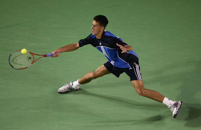 Novak Djokovic retrieves a ball