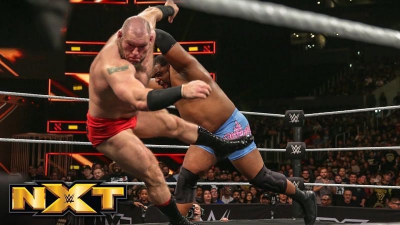 Keith Lee pounces Lars Sullivan out of the ring.