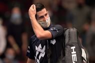 Novak Djokovic leaving court after his defeat to Sonego