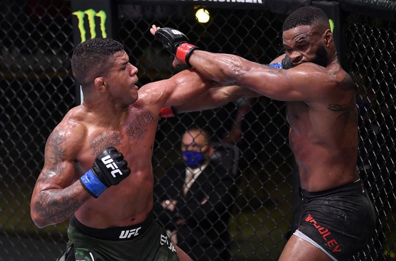 Gilbert Burns of Brazil punches Tyron Woodley in their welterweight fight