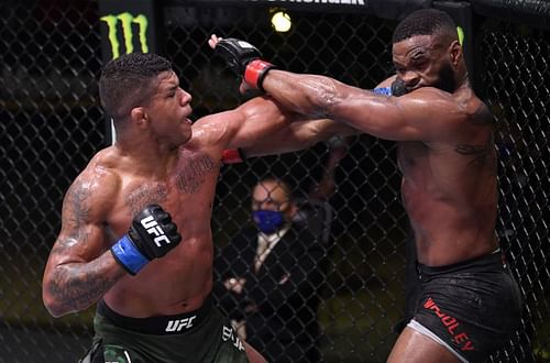 Gilbert Burns of Brazil punches Tyron Woodley in their welterweight fight