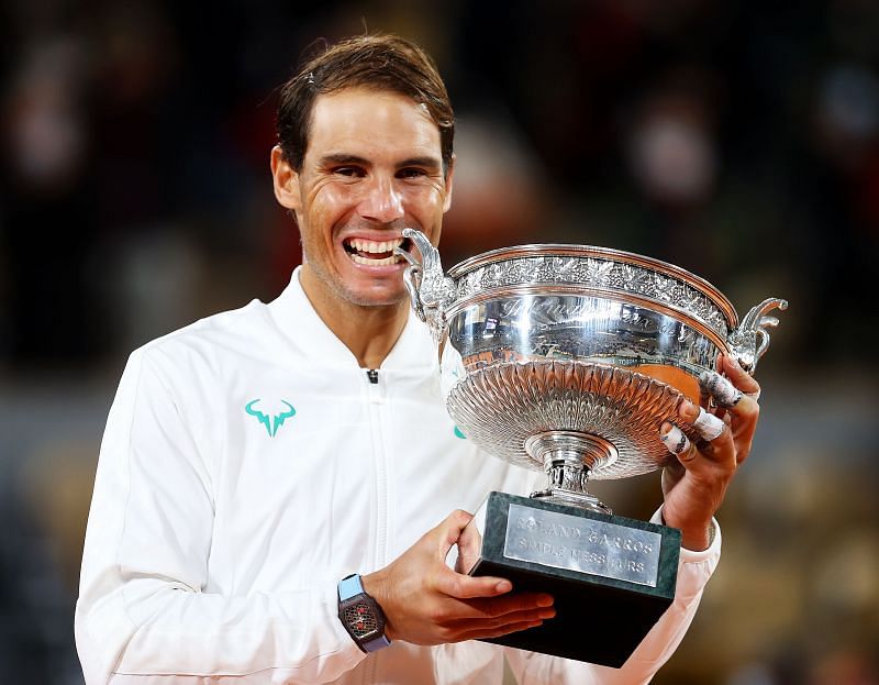 Rafael Nadal poses with the trophy after beating Novak Djokovic to win his 13th Roland Garros title