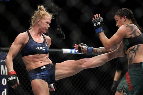 Holly Holm (L) kicks Raquel Pennington in bantamweight bout during UFC 246 