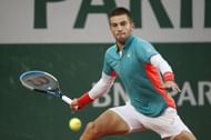 Borna Coric returns a ball