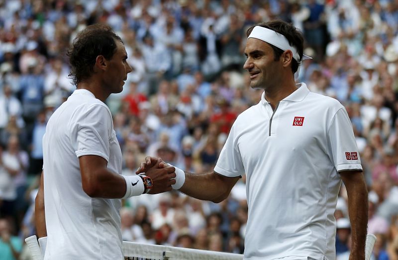 Roger Federer and Rafael Nadal, seen here at Wimbledon last year, are now tied at 20 Grand Slams