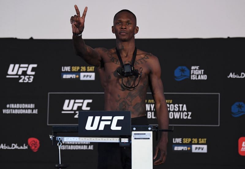 Israel Adesanya of Nigeria poses on the scale during the UFC 253