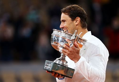 Rafael Nadal bites the trophy after winning the 2020 French Open title earlier this month in Paris