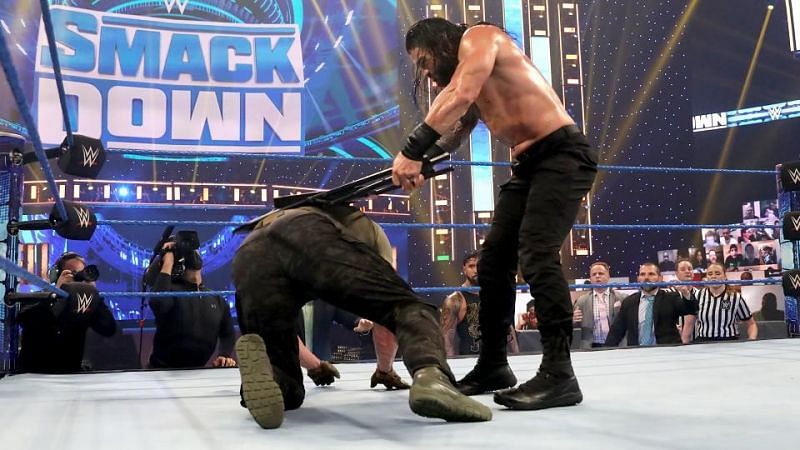 Keith Lee reacts to Roman Reigns unleashing a barrage of chair shots on Strowman