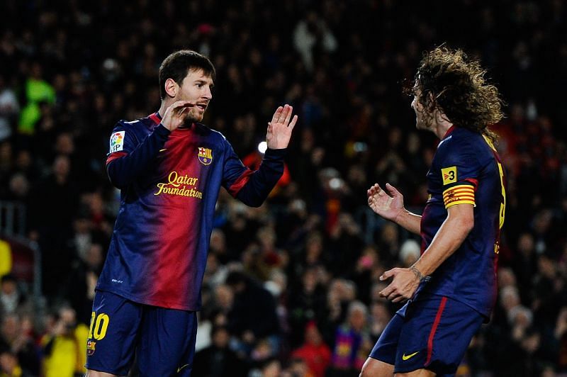 Barcelona&#039;s past and present captains Leo Messi and Carles Puyol