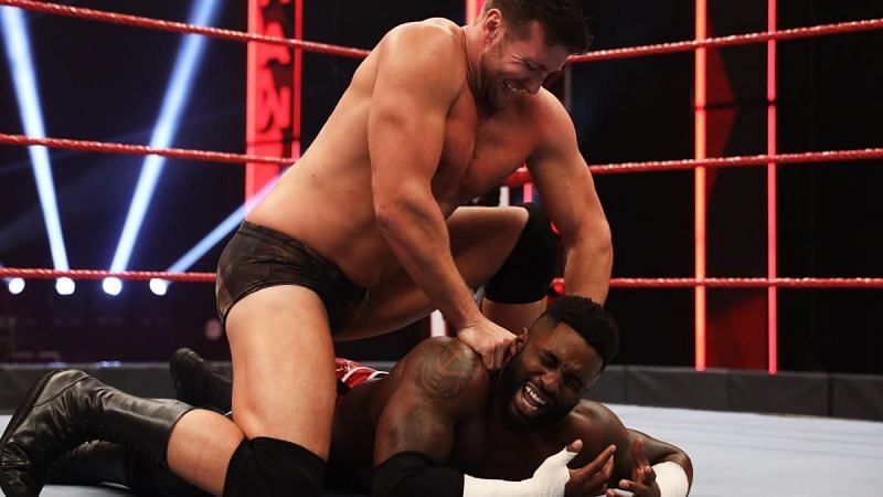 Brendan Vink works on the shoulder of Cedric Alexander on RAW, during his match teaming with Shane Thorne against Cedric Alexander and Ricochet