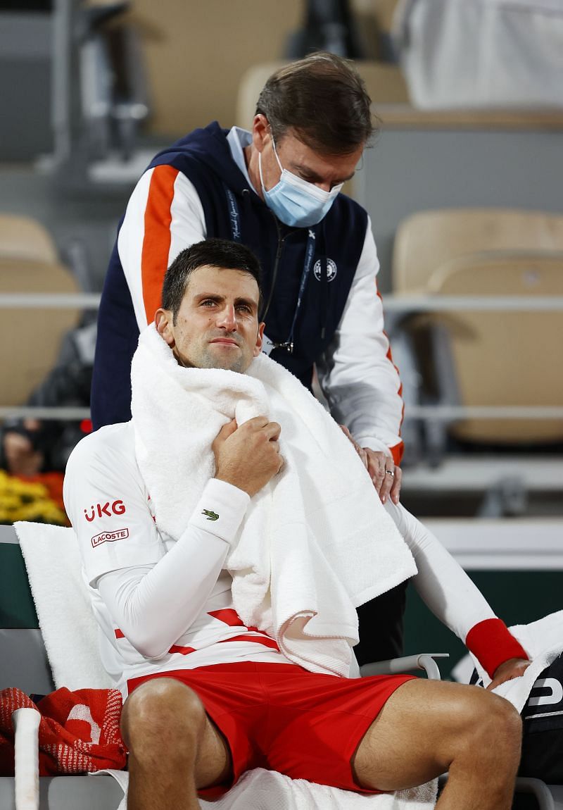 Novak Djokovic receiving medical treatment during his quarterfinal match against Pablo Carreno Busta
