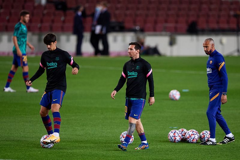 Francisco Trincao and Lionel Messi of FC Barcelona warm up ahead of a game