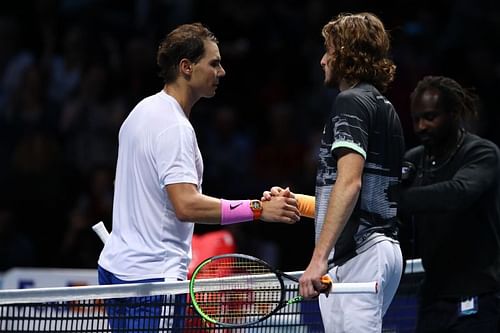 Rafael Nadal and Stefanos Tsitsipas shake hands after their singles match at the 2019 Nitto ATP Finals