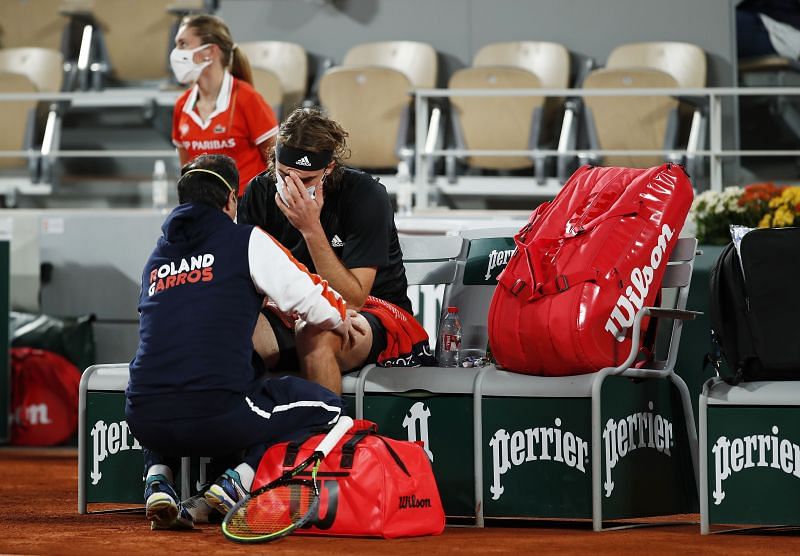 Stefanos Tsitsipas being treated at Roland Garros