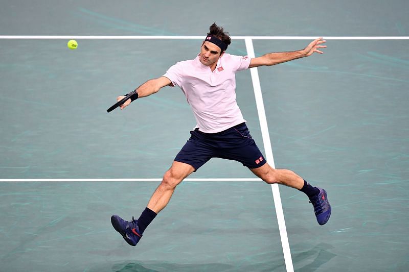 Roger Federer plays a backhand.