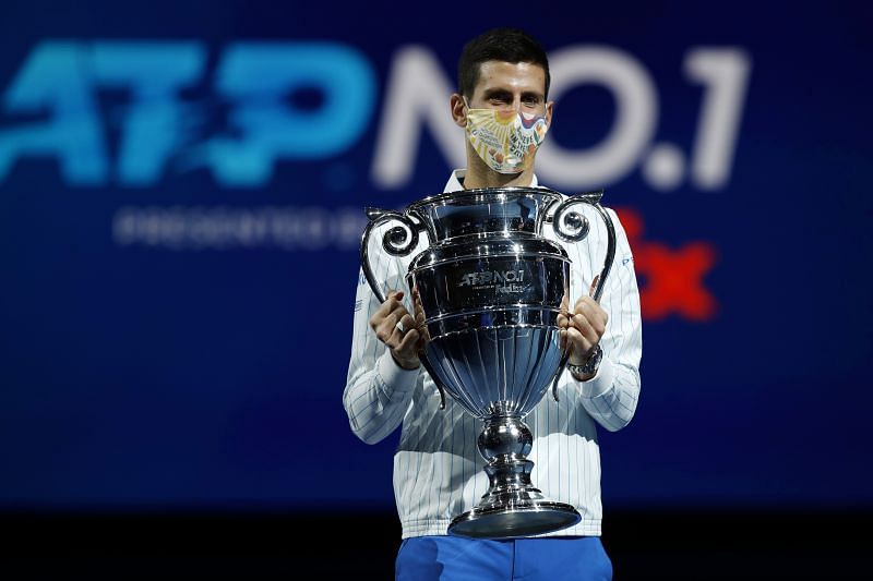 Novak Djokovic celebrates with the year-end World No. 1 trophy