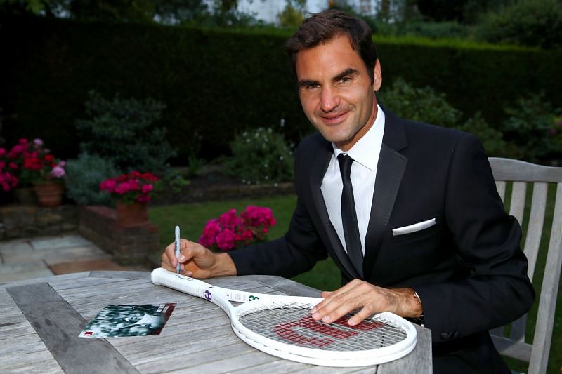Roger Federer celebrates his Wimbledon record with an exclusive commemorative &quot;8&quot; Wilson tennis racket
