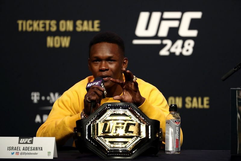 Israel Adesanya talks during a press conference