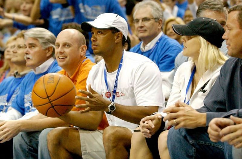 Tiger Woods sitting courtside in an Orlando Magic NBA game.