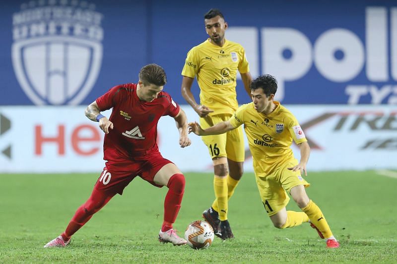 CY Goddard and Gallego fight for the ball in midfield.