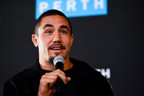 Robert Whittaker takes questions during a UFC 221 media opportunity