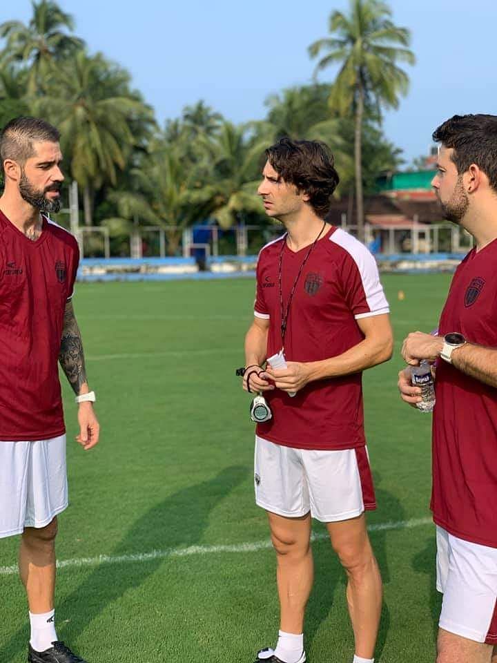 Gerard Nus (center) speaking with his coaching team during a practice session. (Image Courtesy: Neufc Social Media)