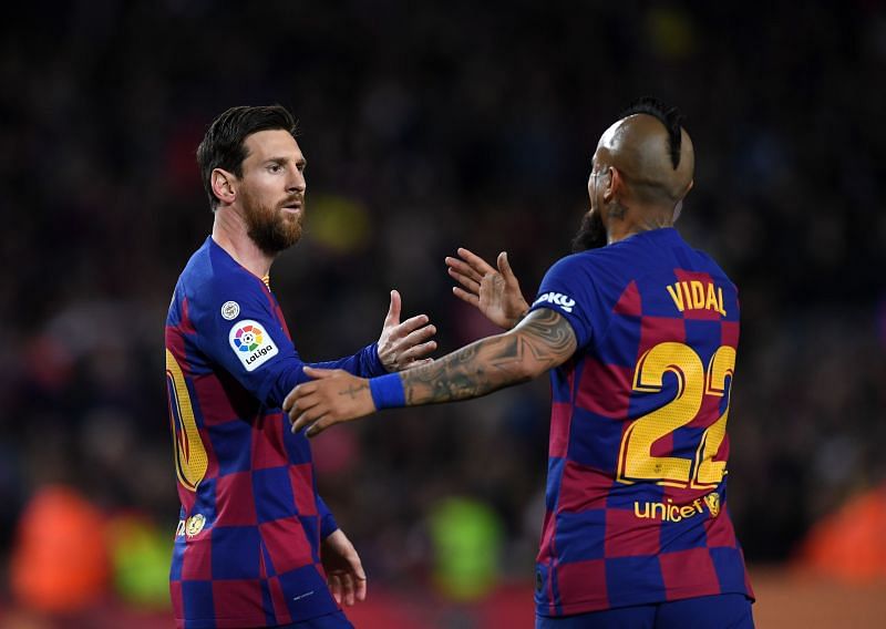 Lionel Messi of FC Barcelona celebrates with Arturo Vidal.