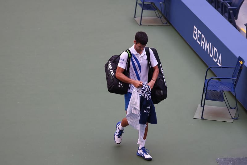Novak Djokovic walks out after being defaulted at the US Open