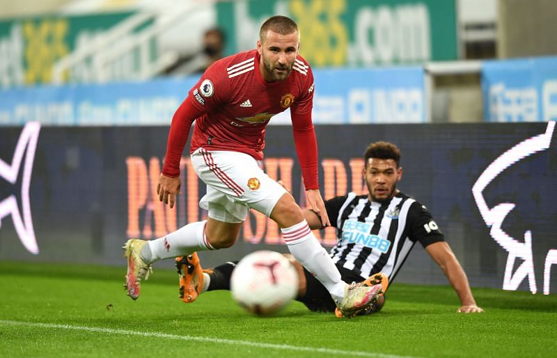 Manchester United&#039;s Luke Shaw beats Joelinton to the ball.