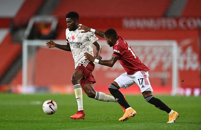 Thomas Partey of Arsenal is put under pressure by Fred of Manchester United