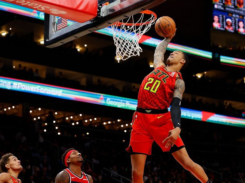 John Collins elevates for a dunk