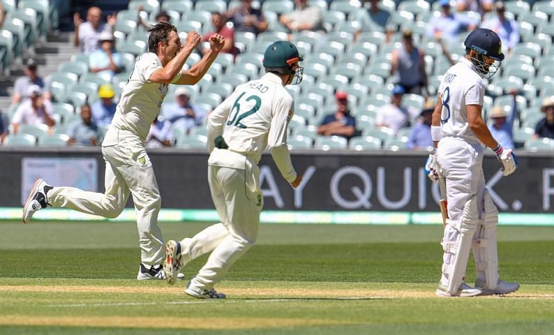 Pat Cummins celebrates after picking up the big wicket of Virat Kohli