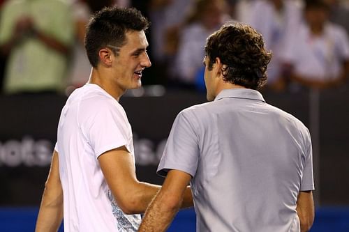 Bernard Tomic (L) and Roger Federer