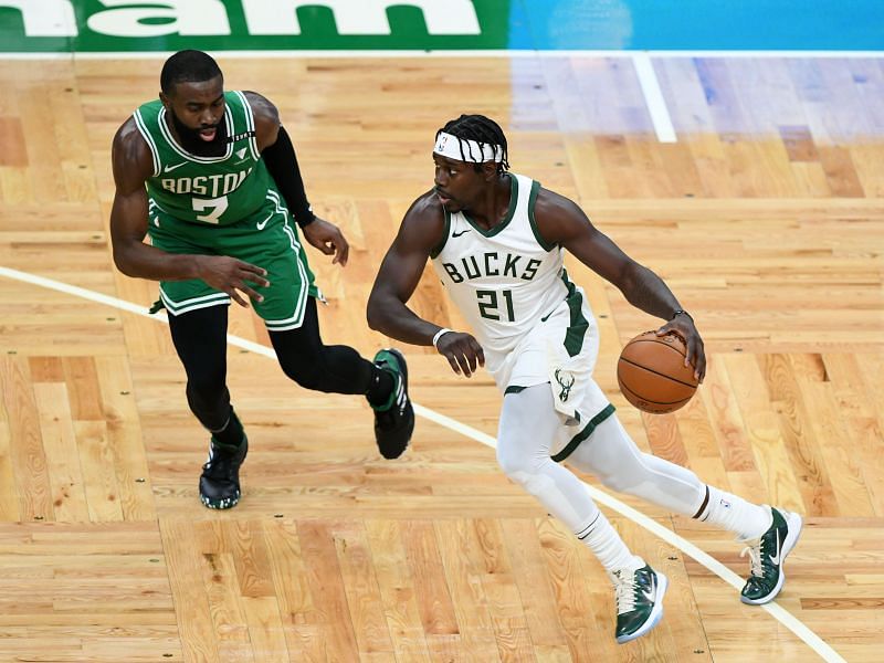 Jaylen Brown attempts to defend against Milwaukee Bucks's Jrue Hoilday