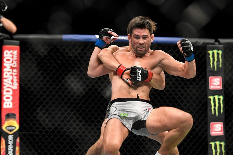 Henry Cejudo (red tape) of the United States looks to take down Dominick Cruz