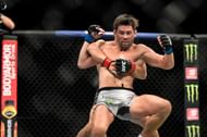 Henry Cejudo (red tape) of the United States looks to take down Dominick Cruz