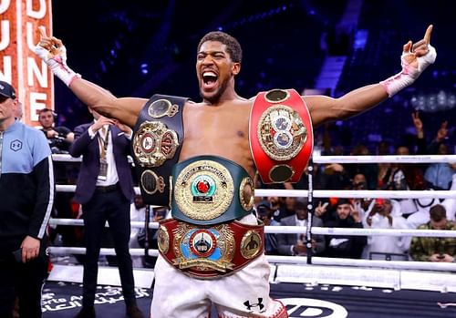 Anthony Joshua with the World Heavyweight titles